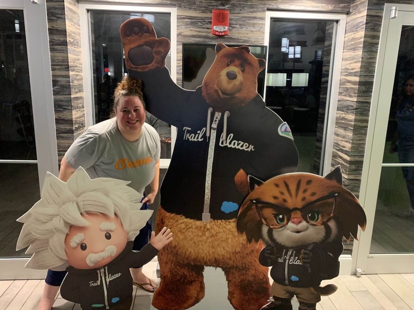Woman with cut outs of Trailblazer mascots.