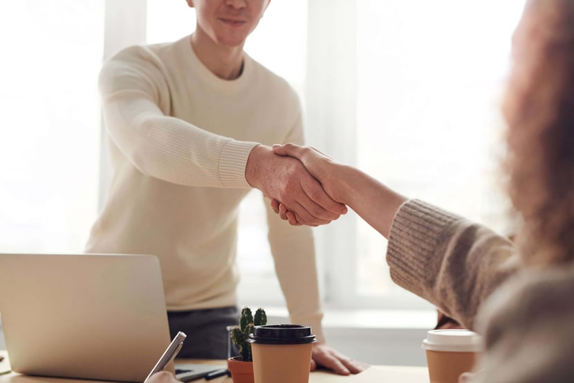 Man shaking hands with woman