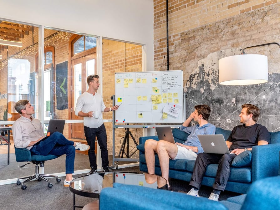 Cirrus Insight. Team works on planning using a whiteboard and sticky notes.