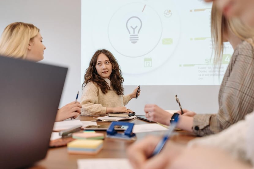 Woman giving sales presentation at table. 