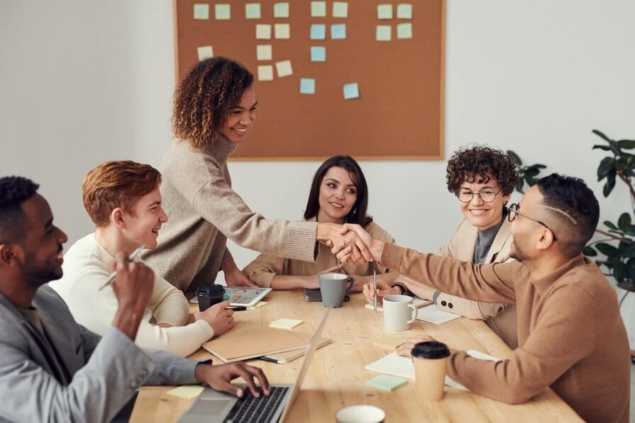 CirrusInsight. Woman shaking hands with her coworker.