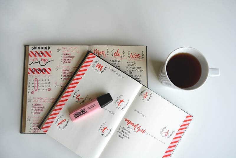 Planner on table with highlighter.