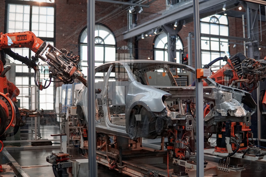 future-of-sales--gray-vehicle-being-fixed-inside-factory-using-robot-machines